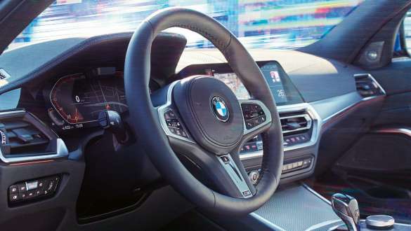 BMW 3er Limousine, Variable Sportlenkung. G20 Seitliche Detailansicht des Cockpits der BMW 3er Limousine mit Fokus auf dem Lenkrad mit variabler Sportlenkung. G20