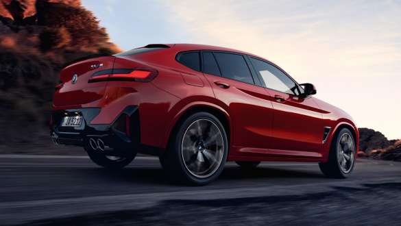 M xDrive BMW X4 M F98 LCI Facelift 2021 BMW X4 M F98 LCI Facelift 2021 M xDrive Dreiviertel-Heckansicht auf der Straße fahrend